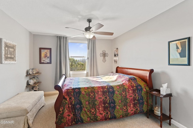 bedroom with a ceiling fan, carpet, and baseboards