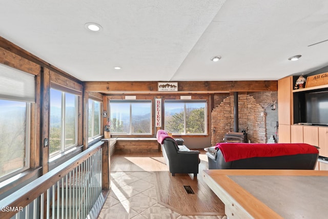 living area with a wood stove and recessed lighting