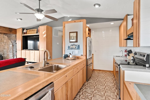 kitchen with under cabinet range hood, stainless steel appliances, a sink, visible vents, and light floors