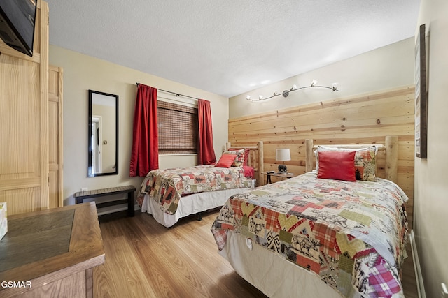 354 E Holly Ridge Rd Ste 301, Gatlinburg, TN 37738 - bedroom featuring a textured ceiling, wood finished floors, and wooden walls