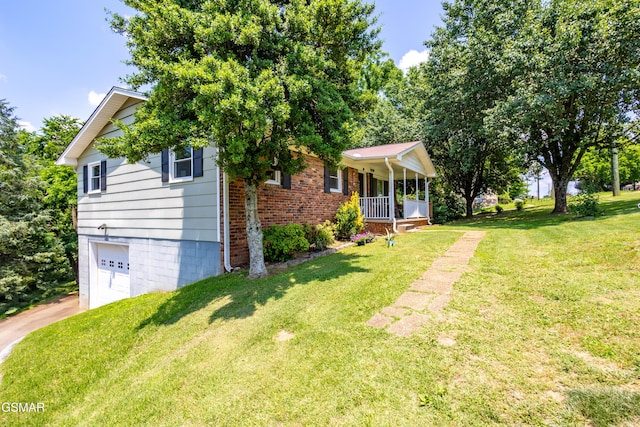 6119 Ridgeview Rd, Knoxville, TN 37918 - view of front facade with covered porch, an attached garage, a front yard, driveway, and brick siding