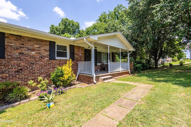 6119 Ridgeview Rd, Knoxville, TN 37918 - view of front facade with covered porch, a front yard, and brick siding