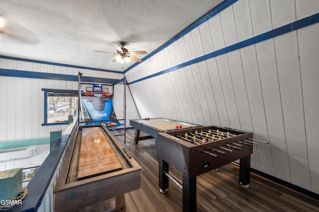 game room featuring crown molding, wooden walls, vaulted ceiling, and dark hardwood / wood-style flooring