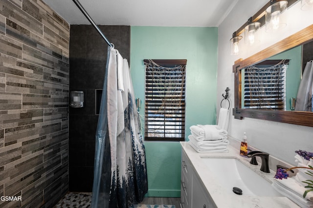 bathroom with a textured ceiling, vanity, and a shower with shower curtain