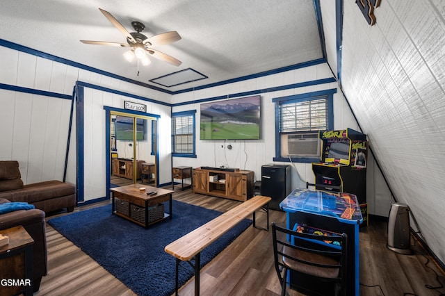 living room with ceiling fan, dark wood-type flooring, a textured ceiling, and cooling unit