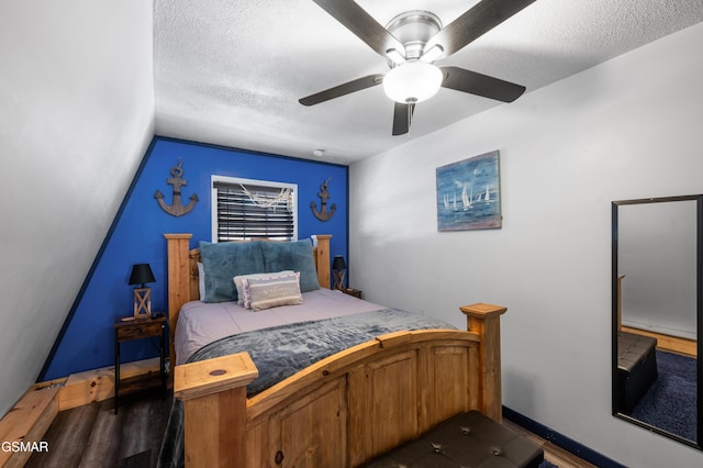 bedroom with ceiling fan and a textured ceiling