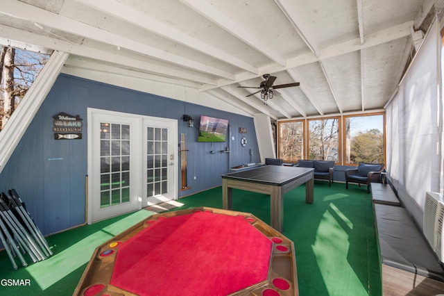 recreation room with ceiling fan, carpet flooring, and vaulted ceiling with beams