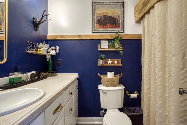 bathroom featuring toilet and vanity