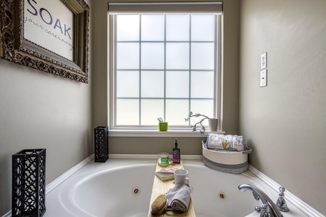 bathroom with a washtub and plenty of natural light