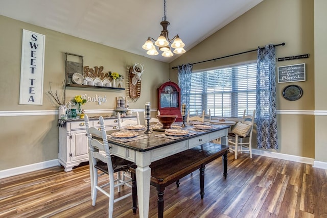 dining area with lofted ceiling, an inviting chandelier, and wood-type flooring