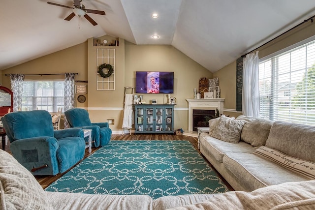 living room featuring vaulted ceiling, ceiling fan, and hardwood / wood-style flooring