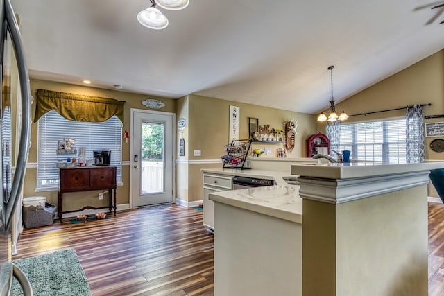 kitchen featuring vaulted ceiling, pendant lighting, an inviting chandelier, white cabinets, and appliances with stainless steel finishes