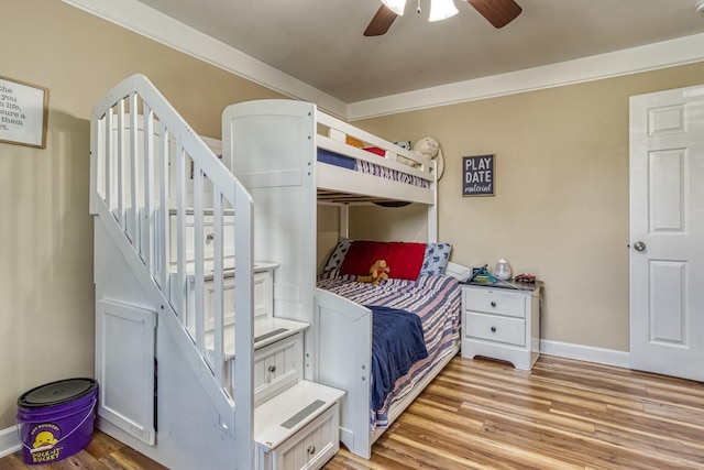 bedroom with ceiling fan, light wood-type flooring, and ornamental molding