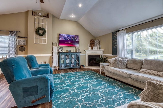 living room featuring ceiling fan, lofted ceiling, and hardwood / wood-style flooring