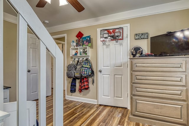 interior space with ceiling fan, hardwood / wood-style flooring, and crown molding