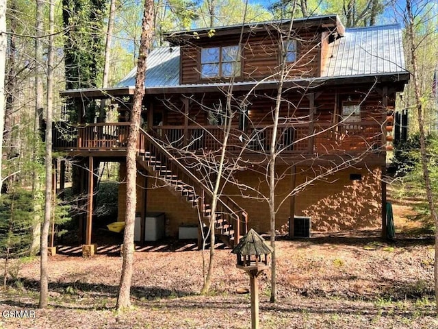 exterior space featuring stairway and metal roof