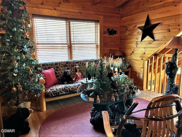 living room with wooden walls and wood-type flooring