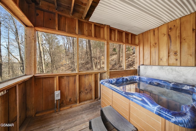 sunroom with a wealth of natural light and a hot tub