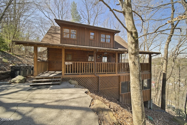 chalet / cabin featuring board and batten siding and a shingled roof