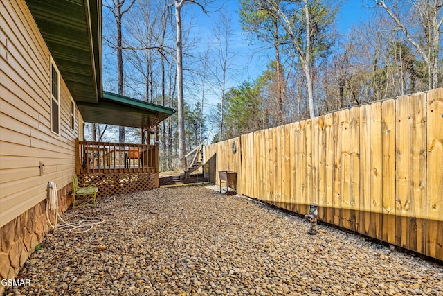 view of yard with fence and a wooden deck