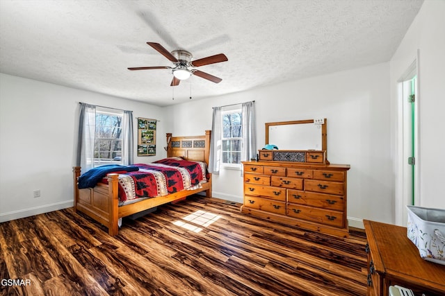 bedroom with a textured ceiling, wood finished floors, baseboards, and ceiling fan