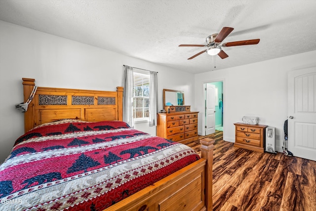 bedroom featuring a textured ceiling, a ceiling fan, and wood finished floors