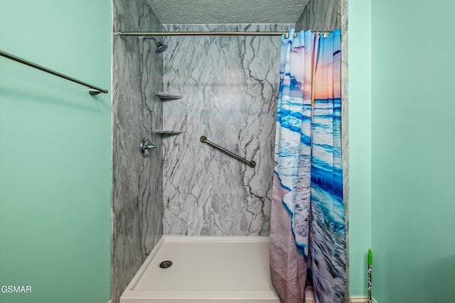 bathroom with a shower and a textured ceiling