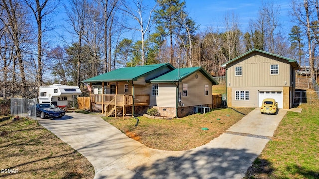 view of front of home with concrete driveway, fence, and covered porch