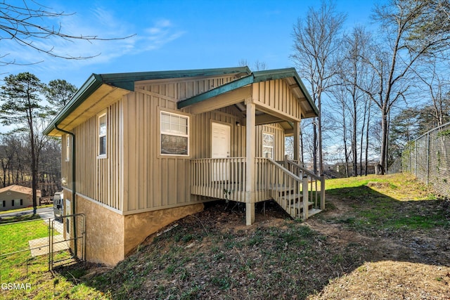 exterior space featuring fence and board and batten siding