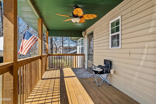 wooden deck featuring ceiling fan