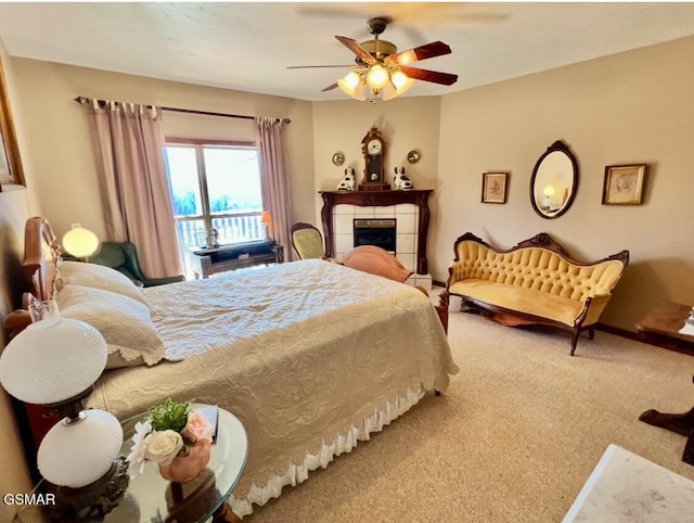 bedroom with ceiling fan, a fireplace, and carpet floors