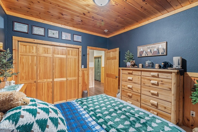 1668 Deerwood Rd, Newport, TN 37821 - bedroom with wainscoting, a textured wall, wood ceiling, and wood finished floors