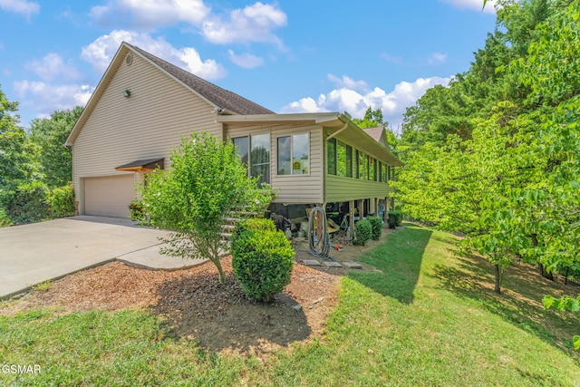 1668 Deerwood Rd, Newport, TN 37821 - view of side of home with a garage, driveway, a yard, and a sunroom