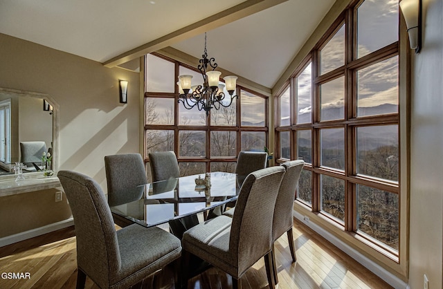sunroom / solarium with a chandelier, beam ceiling, and plenty of natural light
