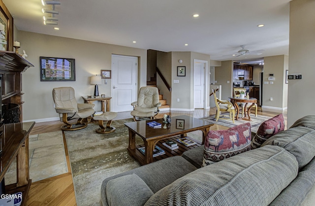 living room with recessed lighting, stairway, and light wood-style floors