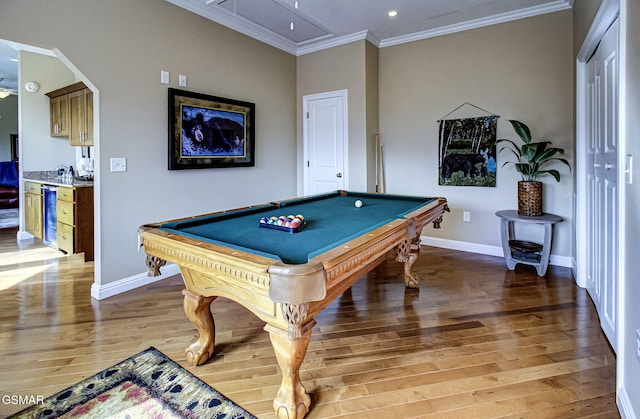 playroom with crown molding, baseboards, attic access, and light wood-style floors