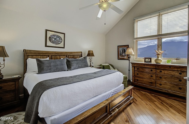 bedroom featuring ceiling fan, wood-type flooring, and lofted ceiling