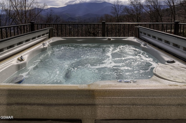 view of pool featuring a mountain view and a hot tub