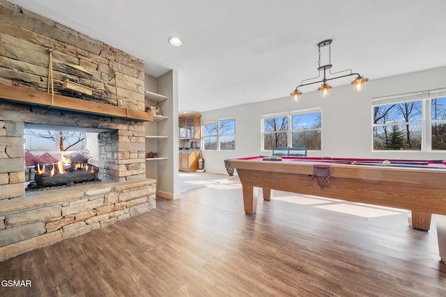 playroom with built in shelves, pool table, a fireplace, and light wood-type flooring