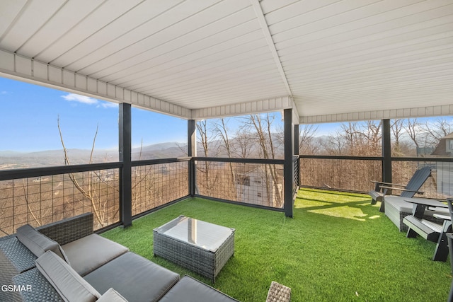 sunroom / solarium with a mountain view and a wealth of natural light