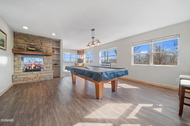 game room featuring hardwood / wood-style flooring, pool table, a fireplace, and built in features