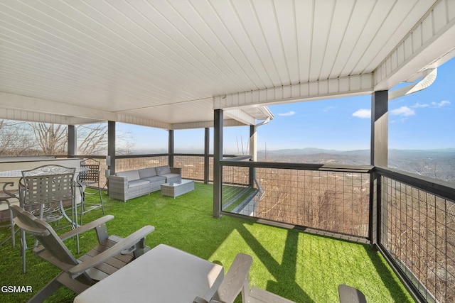 sunroom / solarium with a mountain view