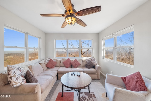 carpeted living room featuring ceiling fan and a healthy amount of sunlight