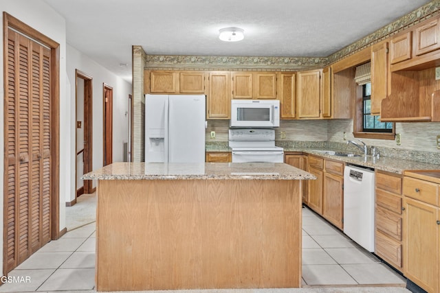 kitchen featuring white dishwasher, a sink, a wealth of natural light, and a fireplace