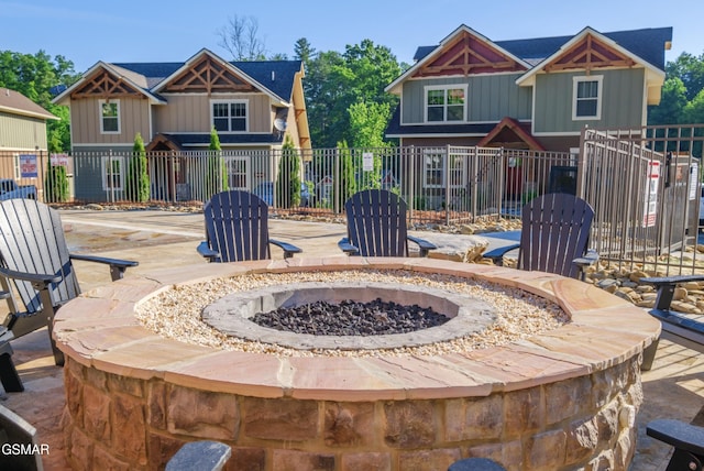 view of patio / terrace with an outdoor fire pit and fence