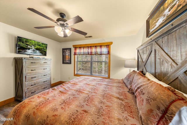 bedroom with ceiling fan, visible vents, and baseboards