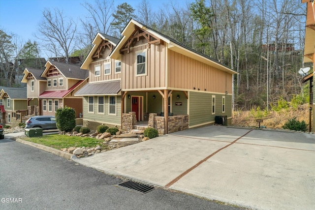 craftsman-style house with board and batten siding, covered porch, and metal roof