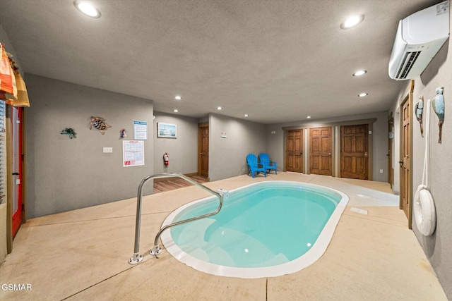 view of swimming pool with a hot tub and a wall mounted air conditioner