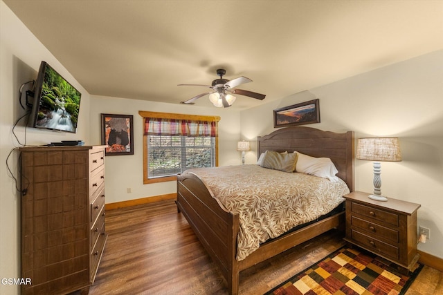 bedroom featuring ceiling fan, baseboards, and dark wood finished floors