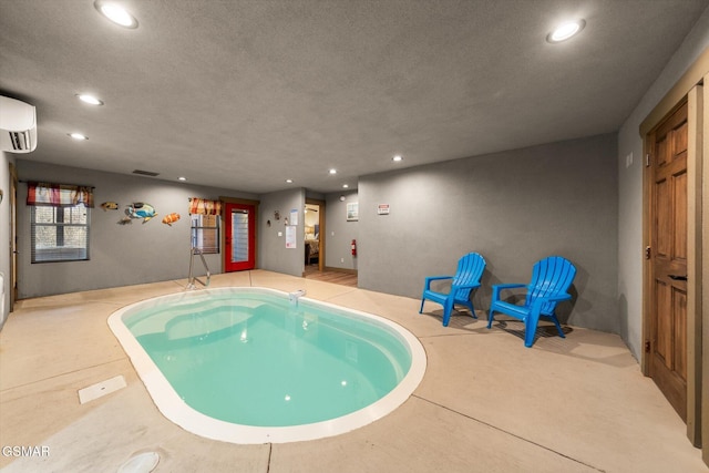 indoor pool featuring a wall unit AC and a hot tub